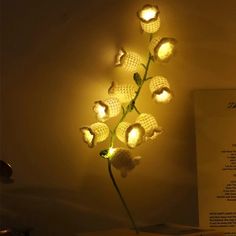 a vase with flowers that are lit up in the dark