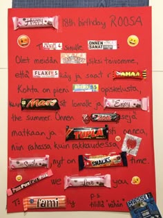 a bulletin board with candy bars on it and some writing on the wall next to it