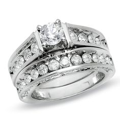 a white gold wedding ring set with two rows of diamonds on the band and an engagement ring