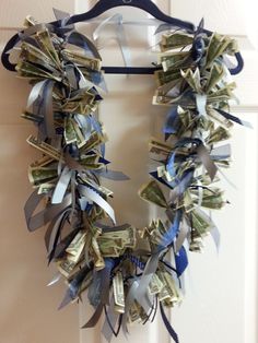 a wreath made out of dollar bills hanging on a door