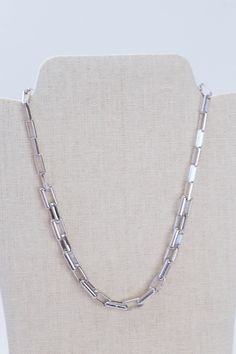 This Rhodium Link Necklace is crafted from silver and features 14" of chain with a secure Claw Clasp Closure for added security. It's the perfect accessory for any occasion. General Info: Fashion jewelry 14" Claw Clasp Closure Imported Silver Link Jewelry, Silver Metal Chain Necklace With Rectangular Links, Modern Silver Chain Necklace With Adjustable Chain, Silver Stainless Steel Necklace With Box Chain, White Gold Metal Box Chain Necklace, Stainless Steel Silver Necklace With Box Chain, Modern Silver Paperclip Chain Jewelry, Silver Metal Chain Necklace With Lobster Clasp, Silver Metal Jewelry With Box Chain