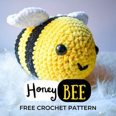 a crocheted stuffed bee sitting on top of a white fluffy blanket with text overlay that reads, honeybee free crochet pattern