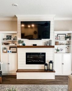 a living room filled with furniture and a flat screen tv mounted on the wall above a fireplace