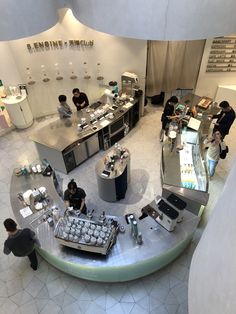 an overhead view of a restaurant with people working in the kitchen and on the counters