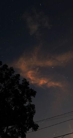 the night sky is lit up with stars and clouds