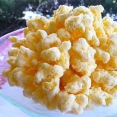 a plate full of popcorn sitting on top of a table