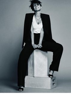 a woman sitting on top of a white box