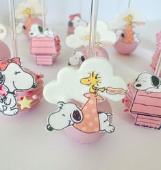 there are many cake pops decorated with cartoon characters on the top one is pink and white