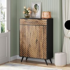 a wooden cabinet sitting on top of a hard wood floor next to a white rug