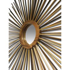 a mirror that is made out of wood and has sticks in the shape of a sunburst