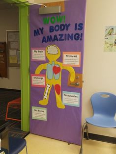 a bulletin board with the words wowi, my body is amazing on it in front of a classroom door