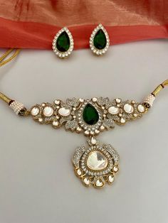 High quality emerald green kundan jewelry set that stands out for being unique and beautiful!  Radiate splendour in this kundan choker set embellished with CZ and green carved stones, delicately handcrafted for you. Details: Necklace Width-2.75 Inches Earrings Length-2.25 Inches Weight of Each Earring-14 gms All products are manufactured using traditional skills from our rich heritage of crafts.  The process of these crafts is essentially manual. Hence, any irregularities or variations are an inherent part of these handcrafting processes. Temple Jewelry Kundan Bridal Necklace With Rose Cut Diamonds, Bollywood Style Bridal Necklace With Rose Cut Kundan Diamonds, Bollywood Bridal Necklace With Rose Cut Diamonds And Kundan, Bollywood Bridal Kundan Necklace With Rose Cut Diamonds, Bollywood Style Bridal Necklace With Rose Cut Diamonds, Festival Gift Kundan Necklace With Rose Cut Diamonds, Festive Kundan Bridal Necklace With Rose Cut Diamonds, Festive Gift Kundan Necklace With Rose Cut Diamonds, Diamond Kundan Necklace For Diwali Gift