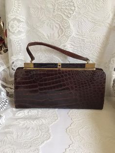 Vintage 1960's large size handbag. It is either Reptile embossed leather OR possibly genuine Alligator. I can feel possible scales, but cannot say for sure if it is real Alligator or not. No makers label or marks inside the bag. This is a nice large size bag. Has one large inside main compartment with a small inside slip and zippered pocket. Has a great SNAP sound when clasp is closed. Because I don't know if this is genuine Alligator or not, I cannot ship the bag international. *CONDITION & MEA Alligator Handbags, Top Handle Bags, Vintage Purses, Vintage Purse, Looks Style, Vintage Handbags, Vintage Frames, Vintage Bags, Vintage 1950s