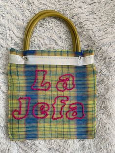 "Handmade \"La Jefa\" Yellow Mercadito bag with Hot Pink embroidered lettering. ONE Available **Size = 7  x 7 Inches NOT INCLUDING THE HANDLES, LOOK AT LAST PHOTO FOR SIZE REFERENCE** Time to create: 2 Days  Ojitos Alegres is a mother/daughter Latina-owned business whose inspiration came from personal experiences with generational teachings of crochet and artisanal work in Mexico. Each piece is made with love, laughter, dancing in the kitchen, listening to old Cumbias and Rancheras, and most imp Ch Matryoshka Bag, Dancing In The Kitchen, Mexican Gifts, Wedding Bags, Wedding Bag, Bags Purses, Mother Daughter, Wedding Accessories, Hot Pink