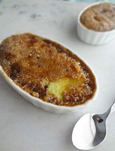 two desserts sitting on top of a table next to each other, one is covered in sugar