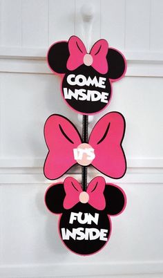 three minnie mouse magnets hanging on the wall with words come inside and fun inside