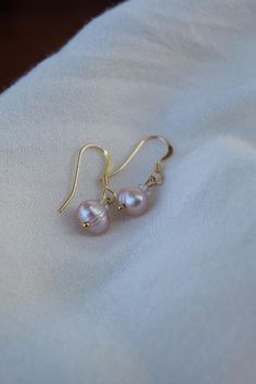 Handmade with 14k gold filled materials, a swarovski crystal and a champagne/peach fresh water pearl. Pearls are associated with commitment, feminine energy and inner wisdom. Elegant Pink Gold Hypoallergenic Jewelry, Elegant Hypoallergenic Pink Gold Jewelry, Delicate Hypoallergenic Rose Gold Pearl Earrings, Hypoallergenic Rose Gold Pearl Earrings, 14k Rose Gold Pearl Earrings Gift, Elegant Hypoallergenic Pink Gold Earrings, Rose Gold Pearl Earrings With Ear Wire For Anniversary, Champagne Color Drop Earrings For Gift, Elegant Pink Gold Jewelry With Ear Wire