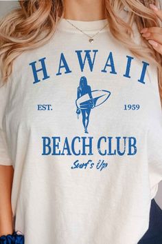 Stay cool on the beach with our Hawaii Beach Club Surfs Up Graphic Tee. Made for beach-goers and surfers alike, this tee features our exclusive design and is perfect for showing off your love for all things sun, sand, and waves. Get yours now and hit the beach in style. Hawaii Beach Club surfs up graphic tee premium cottonunisex sizingclassic fit Sporty Graphic Print Tops For Beach, Sporty Graphic Print Beach Tops, Beach Graphic Tee With Graphic Design, Graphic Tee T-shirt For Beach With Back Print, Sporty Graphic Print T-shirt For Beach Season, Beachy Letter Print T-shirt For Surfing, Sporty Beach T-shirt With Graphic Print, White Surfing T-shirt For Vacation, Surfing Graphic Tee With Back Print