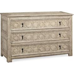 an old white dresser with ornate carvings on the top and bottom drawer, against a white background