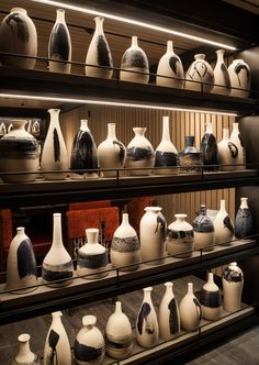 many white and black vases are on shelves