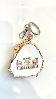 a piece of wood with a keychain hanging from it's side on a white surface