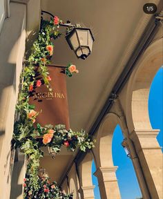 an arch with flowers on it and a bag hanging from the ceiling in front of it