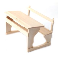 a wooden toy bench sitting on top of a white table