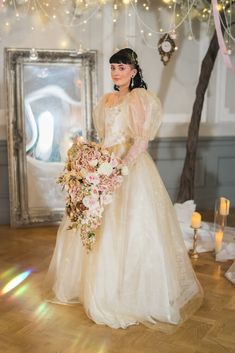 a woman in a wedding dress holding a bouquet