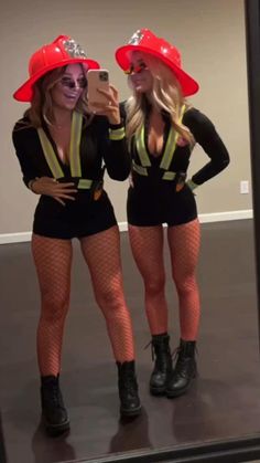 two women dressed in costumes taking a selfie