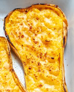 two slices of baked potato sitting in a white dish