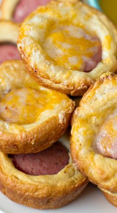 several pastries on a plate next to a cup of coffee