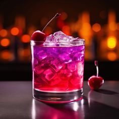 a glass filled with ice and cherries on top of a table