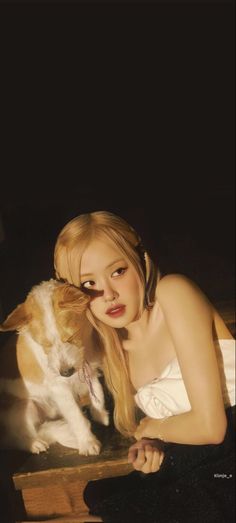 a woman in white dress sitting next to a dog