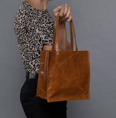 "Check out other colors of this bag style here: https://www.etsy.com/shop/bags1and1stuff?ref=hdr_shop_menu&section_id=15504059 A small leather tote to use when going out, this is what makes this bag worth purchasing for your own use. This simple leather tote is made out of leather and is sure to suit the outfit you'll be wearing for the party or any special occasion you'll be attending. Though it is small in size, this small grey handbag is sure to maximize your look as it is able to give the be Satchel Box Bag, Square Soft Leather Bag For Daily Use, Daily Use Square Bag In Soft Leather, Brown Rectangular Box Bag For On-the-go, Rectangular Soft Leather Box Bag For Shopping, Medium Shoulder Bag For Daily Use, Everyday Brown Square Bag, Square Soft Leather Box Bag For Daily Use, Rectangular Leather Box Bag For Shopping