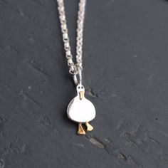 "Tiny Silver and Gold Handmade Duck Necklace Unveil your elegance and embrace the tranquillity of nature with our Tiny Silver and Gold Handmade Duck Necklace. This dainty masterpiece effortlessly complements your individuality, serving as a reminder to stay balanced and navigate life's waters with grace. Elegance meets whimsy in this exquisite piece of jewellery that captures the charm of nature's gentlest creature. Our Tiny Silver and Gold Handmade Duck Necklace is a symbol of grace and resilience, perfect for those who appreciate the beauty of simplicity. Features: Artisan Craftsmanship: Each necklace is meticulously handcrafted by our skilled artisans, ensuring a unique and high-quality piece that reflects their passion and dedication. Mixed Metals Magic: The intricate duck charm is ski Duck Necklace, Grace Symbol, Duck Gifts, Duck Duck, Christmas Gifts For Husband, Bird Necklace, Necklace Chain Lengths, Gift For Woman, Butterfly Jewelry