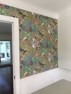 an empty room with a wallpaper pattern on the wall