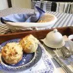 a blue and white plate topped with muffins on top of a wooden table