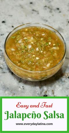 a glass bowl filled with food sitting on top of a marble counter next to a sign that says easy and fast jalapeno salsa