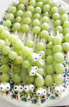 grapes are arranged on toothpicks in the shape of animals