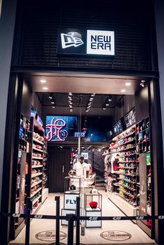 the entrance to a new era store with shoes and other items on display in it