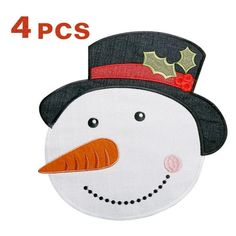 a snowman wearing a top hat with holly leaves on it's head and nose