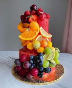 a cake made out of fruit is sitting on a table