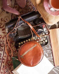 Brown round leather purse. This beautiful leather handcrafted bag has an outer pocket at the front which fastens with a zip. It also has an open space inside big enough to fit a cell phone and your daily essentials, plus a small pocket inside that also secures with a zip to place your money. All of our products are handmade with the best and highest quality leather from our beloved island of ''Crete''. The leather used for each item may be irregular in terms of colour and texture due to its natu Leather Shoulder Bag With Detachable Strap And Round Case, Everyday Leather Shoulder Bag With Round Case, Brown Round Case Shoulder Bag For Everyday, Round Crossbody Bag, Round Purse, Handcrafted Bags, Round Bag, Round Leather, Small Crossbody Bag