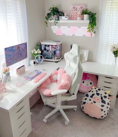 a white desk topped with a computer chair next to a pink teddy bear pillow on top of it