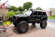 a black jeep parked in front of a house