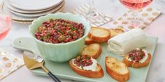 there is a plate with bread and other food on it next to some wine glasses