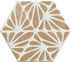 a white and brown hexagonal tile with an intricate design on the outside of it