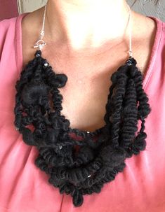 a woman wearing a black crocheted necklace