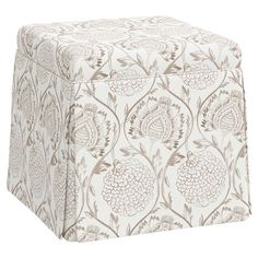 a white and brown ottoman with floral designs on it's sides, sitting in front of a white background