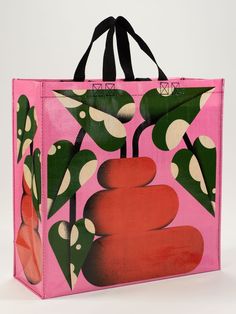 a pink shopping bag with an image of flowers and rocks on the front, against a white background